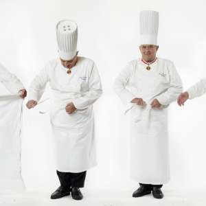 Paul Bocuse knoting his apron - Photo Stéphane de Bourgies
